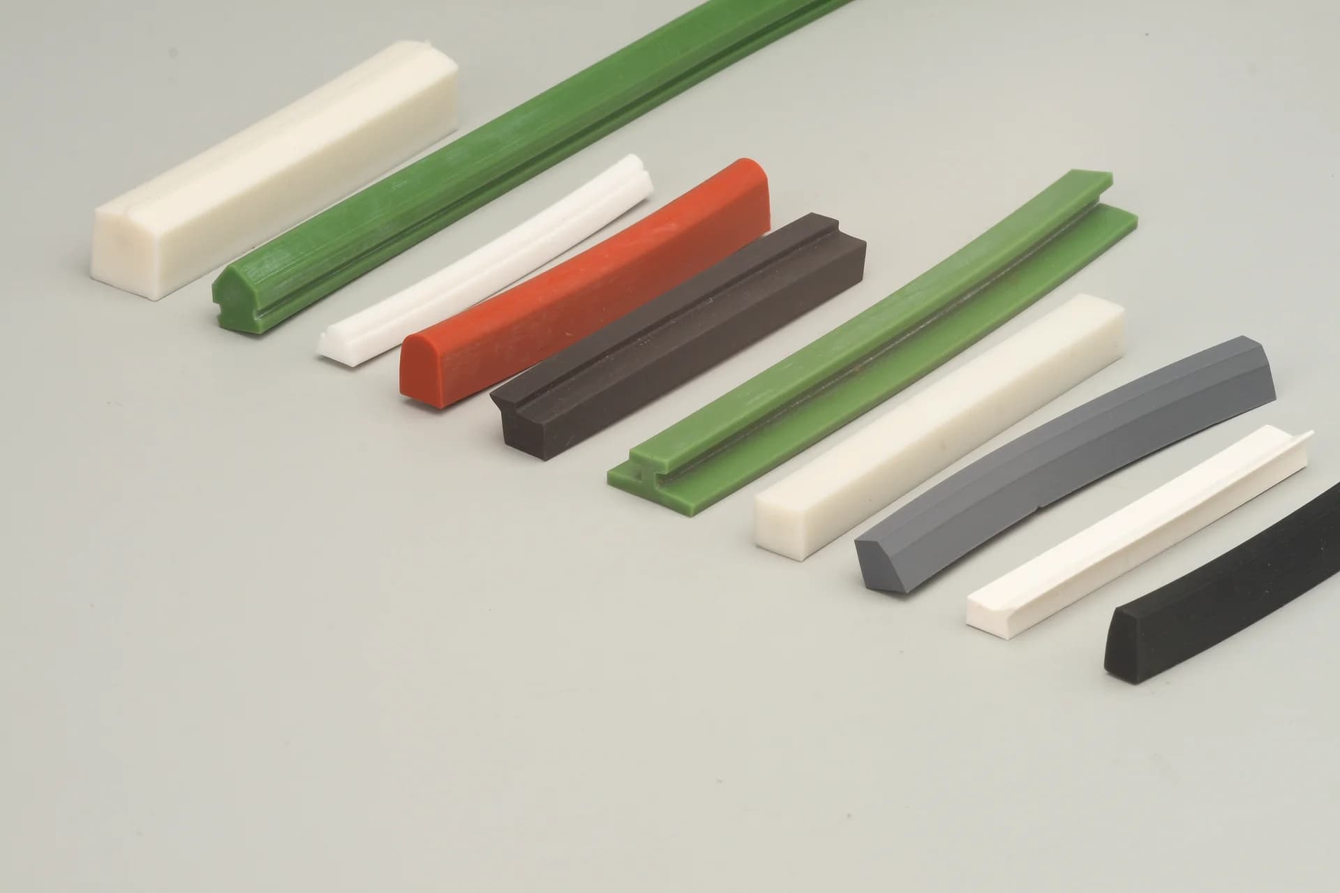 Extruded profiles in white, green, red, grey and black compounds