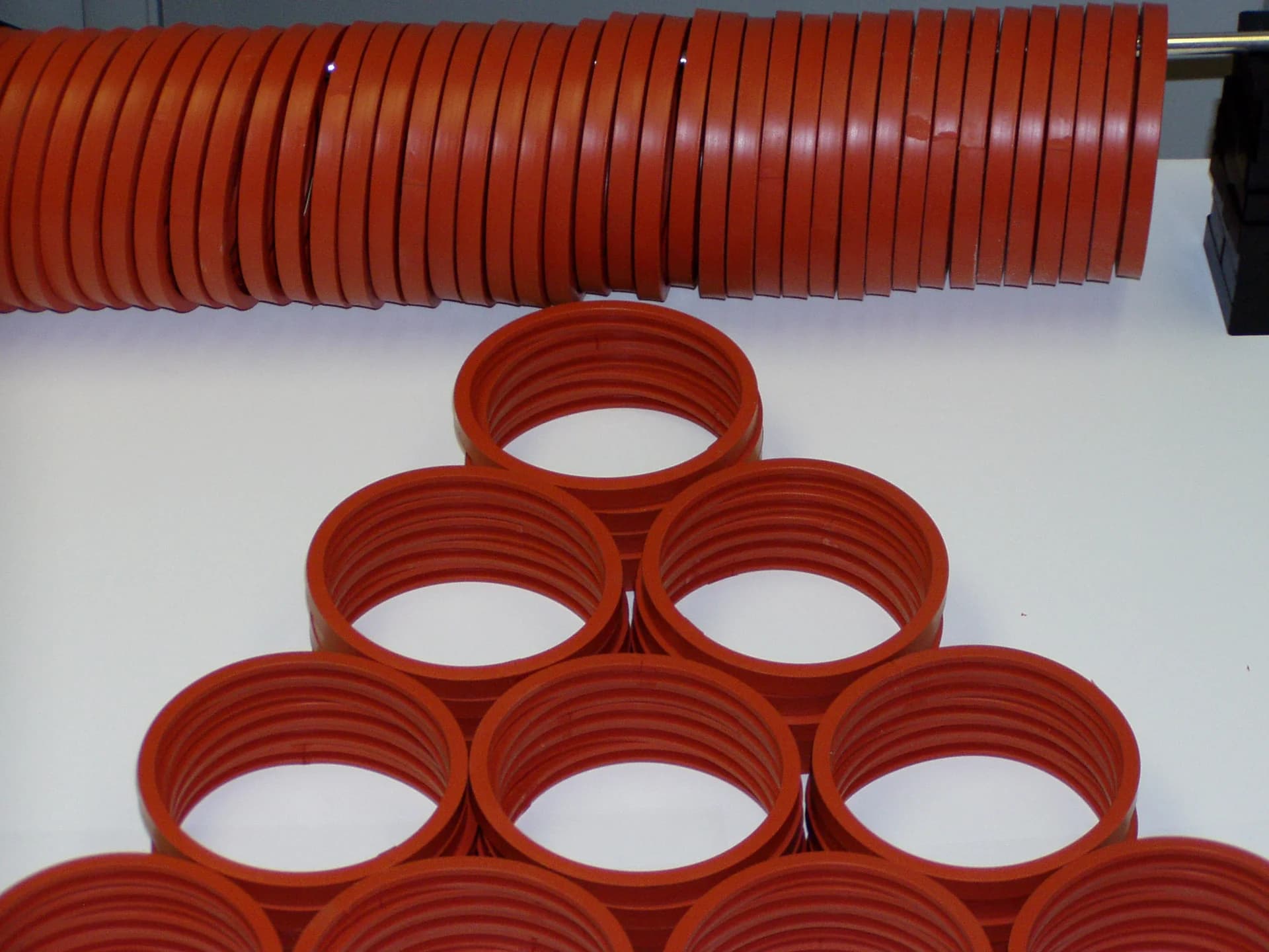 Spliced red silicone gasket rings stacked together